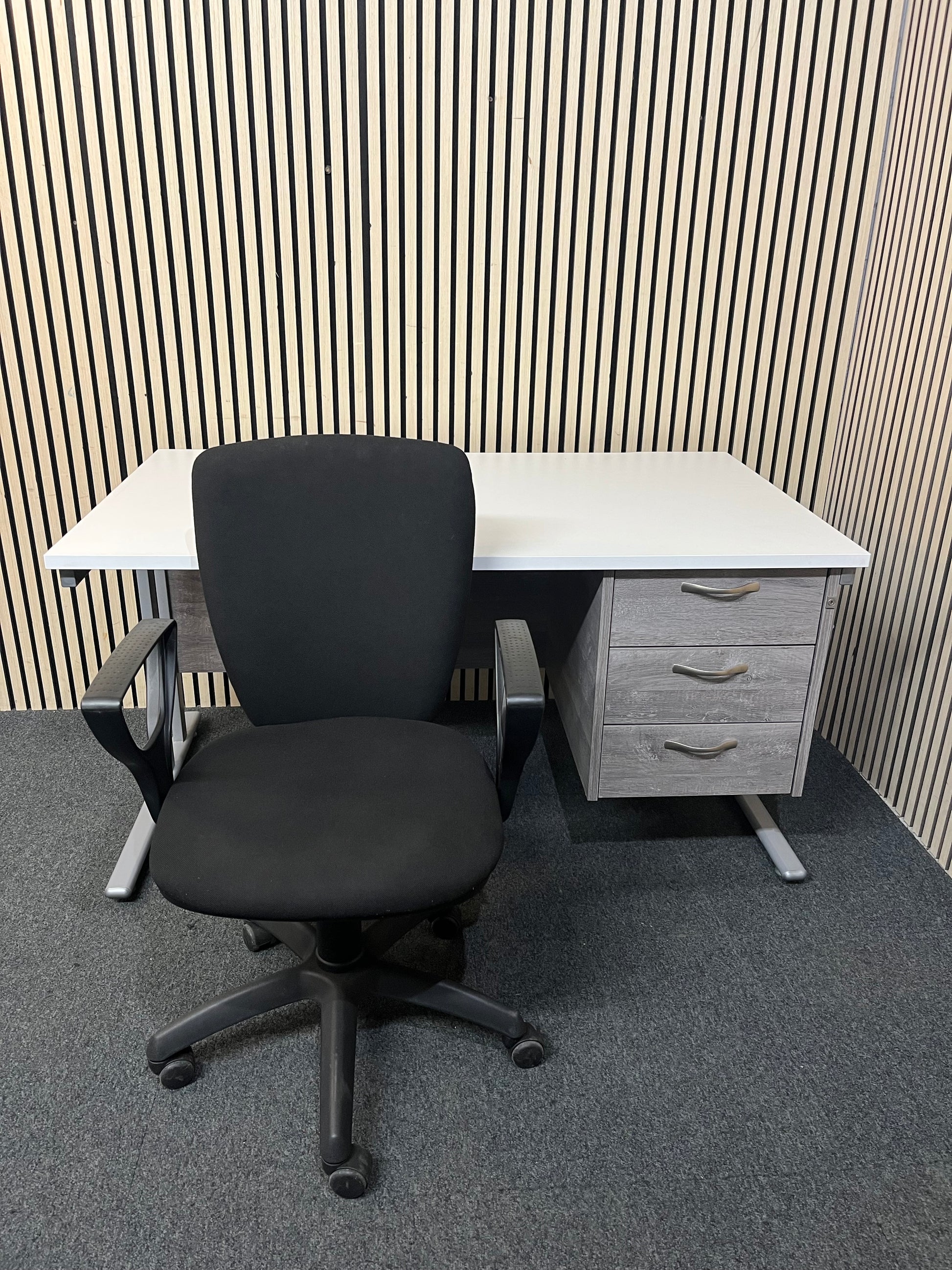 White cantilever framed 1400 x 800 desk with grey oak fixed pedestal and modesty panel