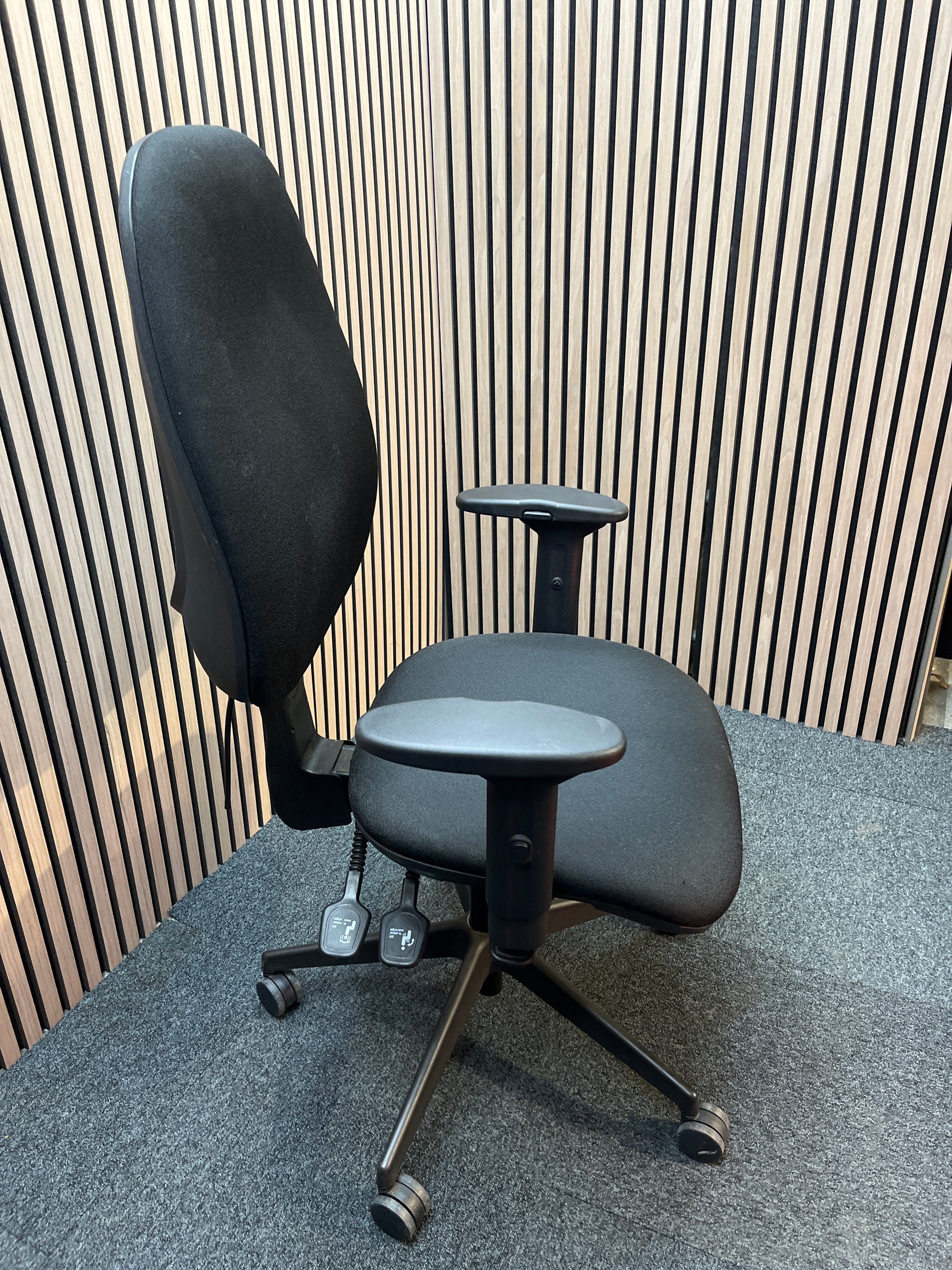 Black fabric ortho swivel
chair with adjustable arms and pump up lumbar support
