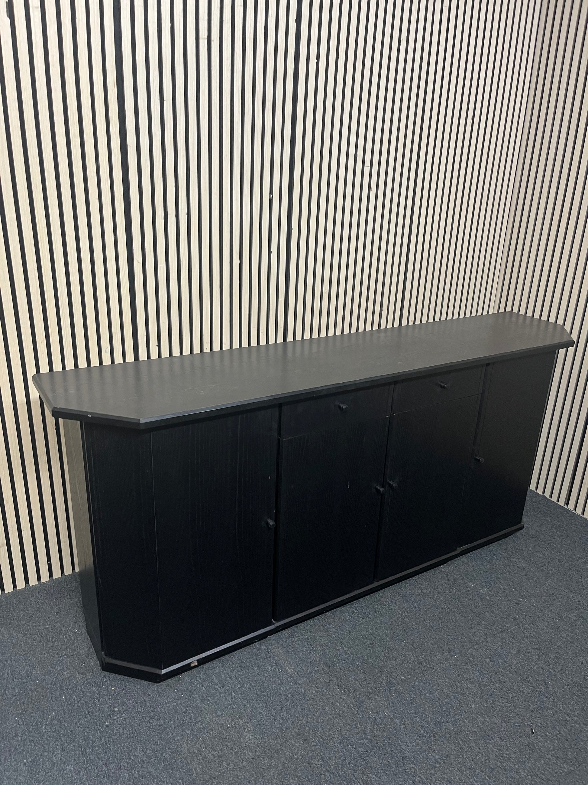Black low sideboard with three storage doors, good condition. 44030