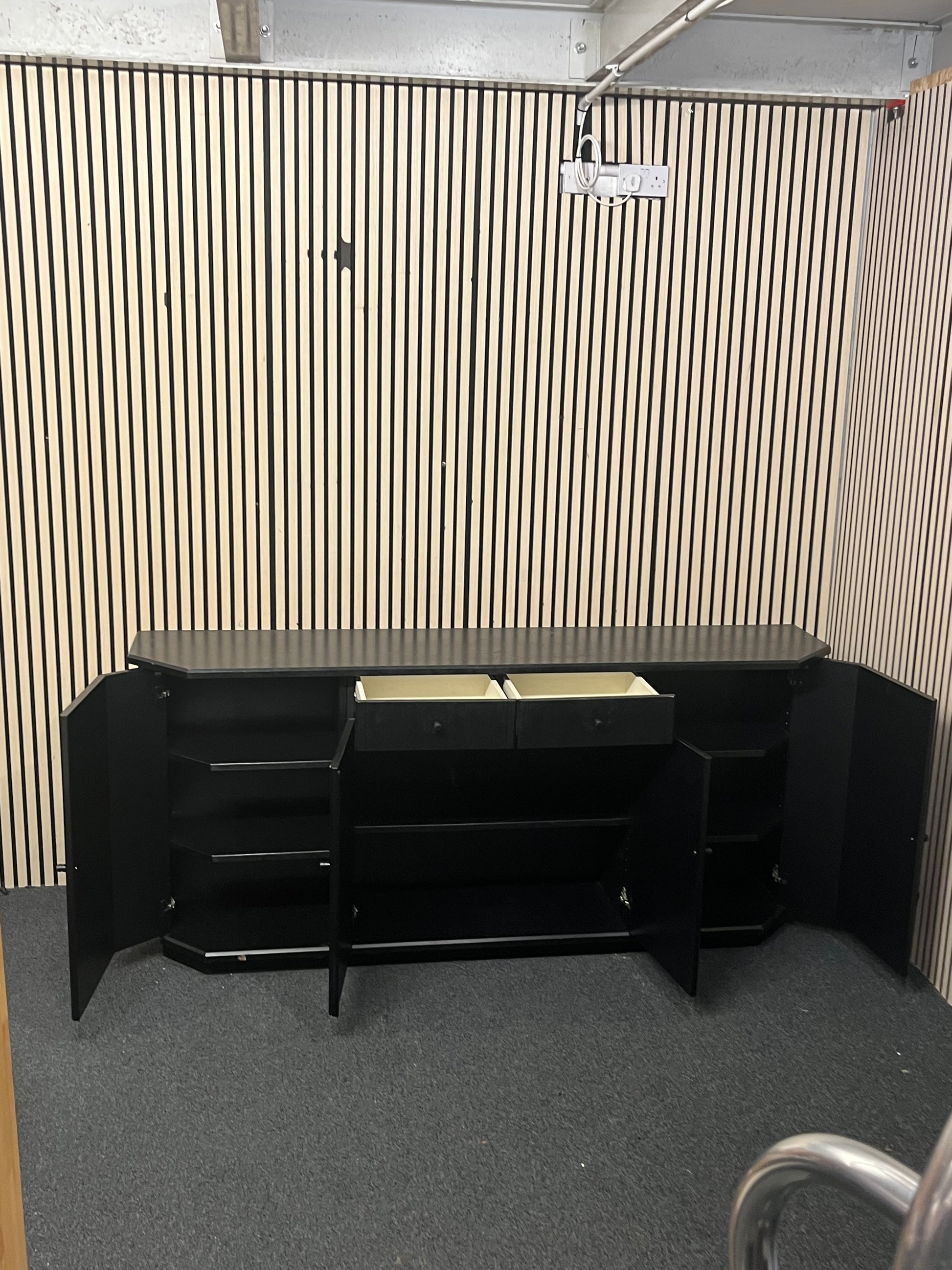 Black low sideboard with three storage doors, good condition. 44030