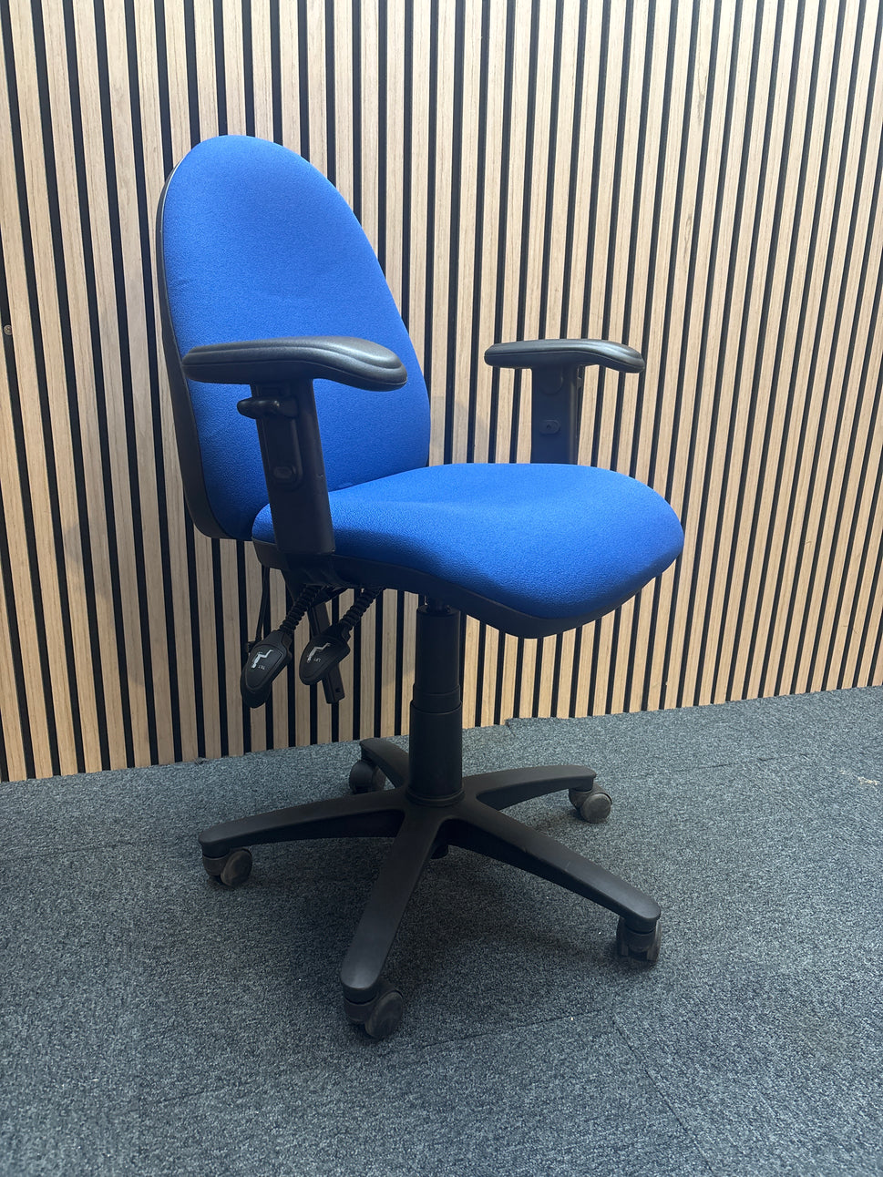 Jota medium back swivel chair in dark blue fabric with pump up lumbar support and height adjustable arms.