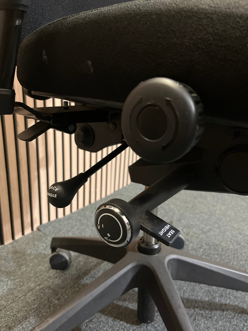 Black fabric fully ortho swivel chair with adjustable arms and high back in black fabric