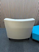 Two-piece curved fabric seating modules in grey and teal blue.