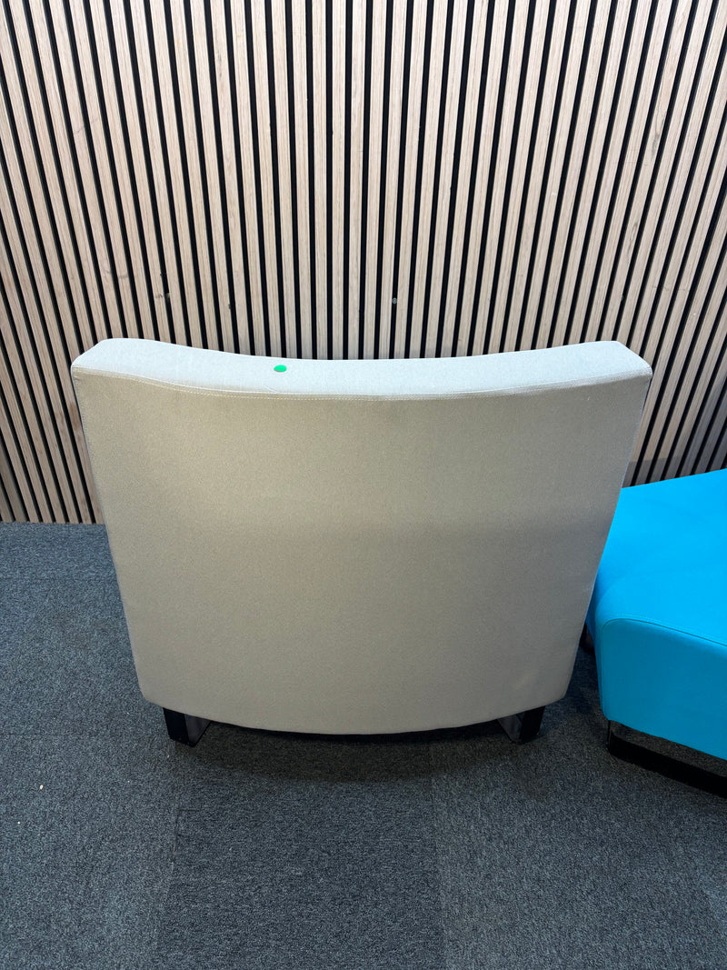 Two-piece curved fabric seating modules in grey and teal blue.