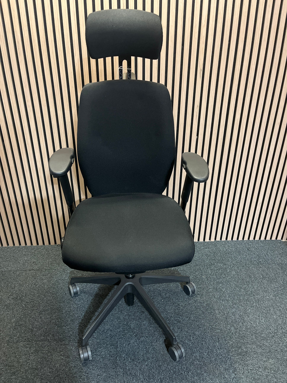 Black fabric fully ortho swivel chair with adjustable arms and high back in black fabric