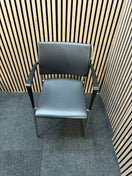 Black pu leatherette stacking chair with arms