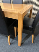Rectangular beech dining table (L 150 x W 90 cm) with 6 black leatherette dining chairs 43505