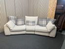 Large curved three-seater fabric sofa with matching scatter cushions. 44592