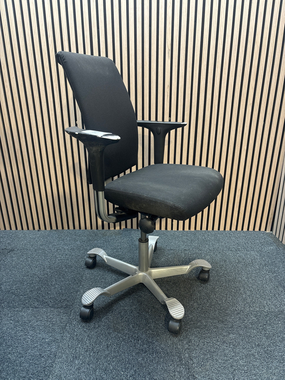 Black fabric swivel chair with sliding away arms