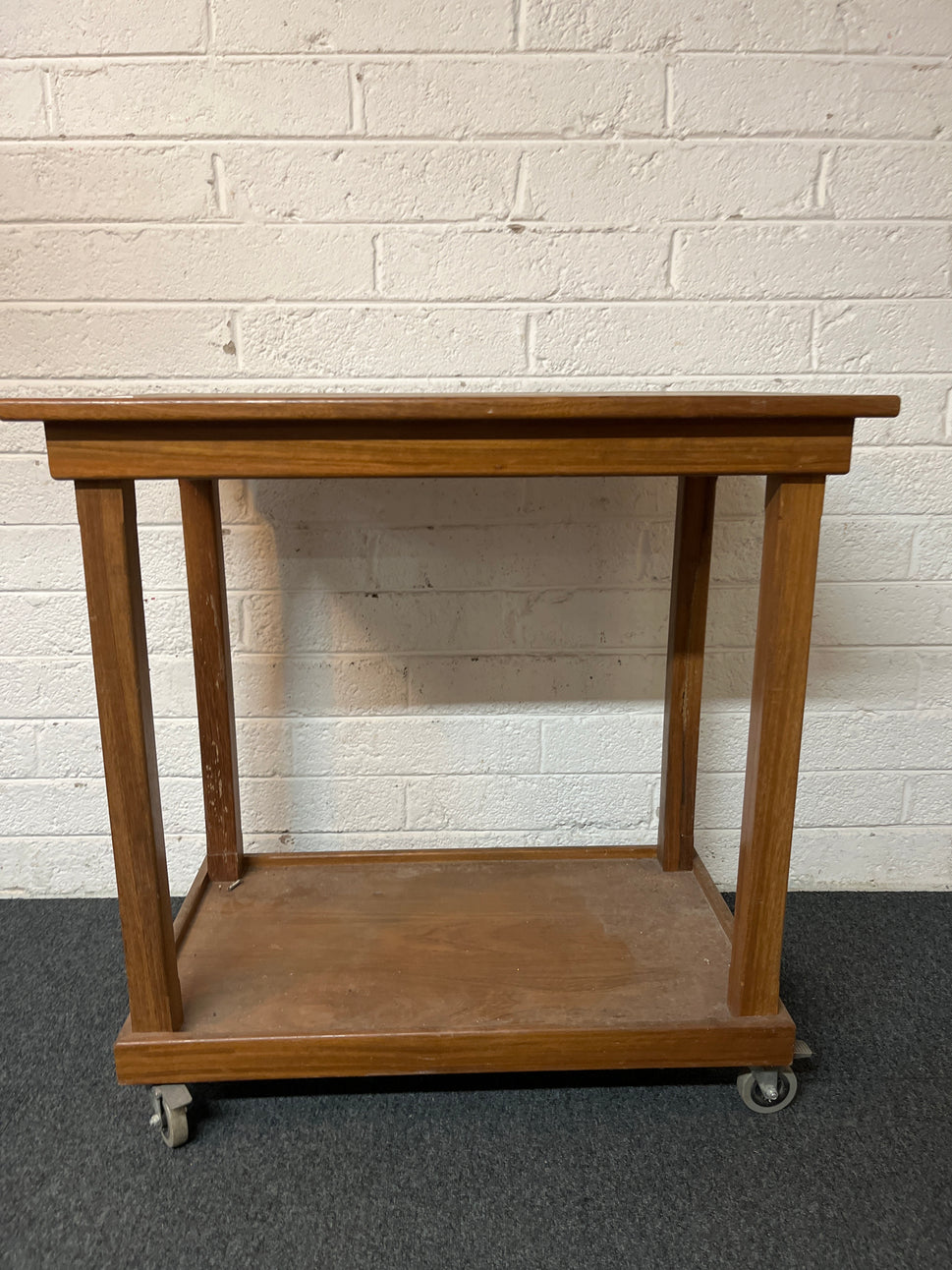 Stained pine high table with circular designs on castors (H 92 x W 90 x D 55 cm) 1325