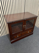 Dark wood TV unit with leaded glass doors and drawers. 44509