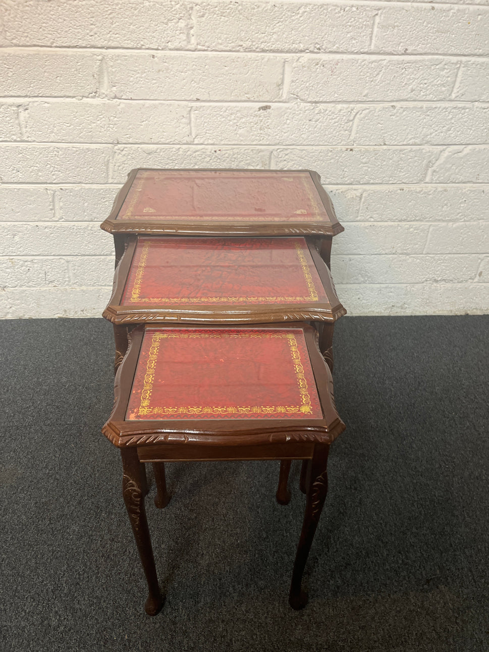 Mahogany nest of tables with glass top and carved detailing 1325
