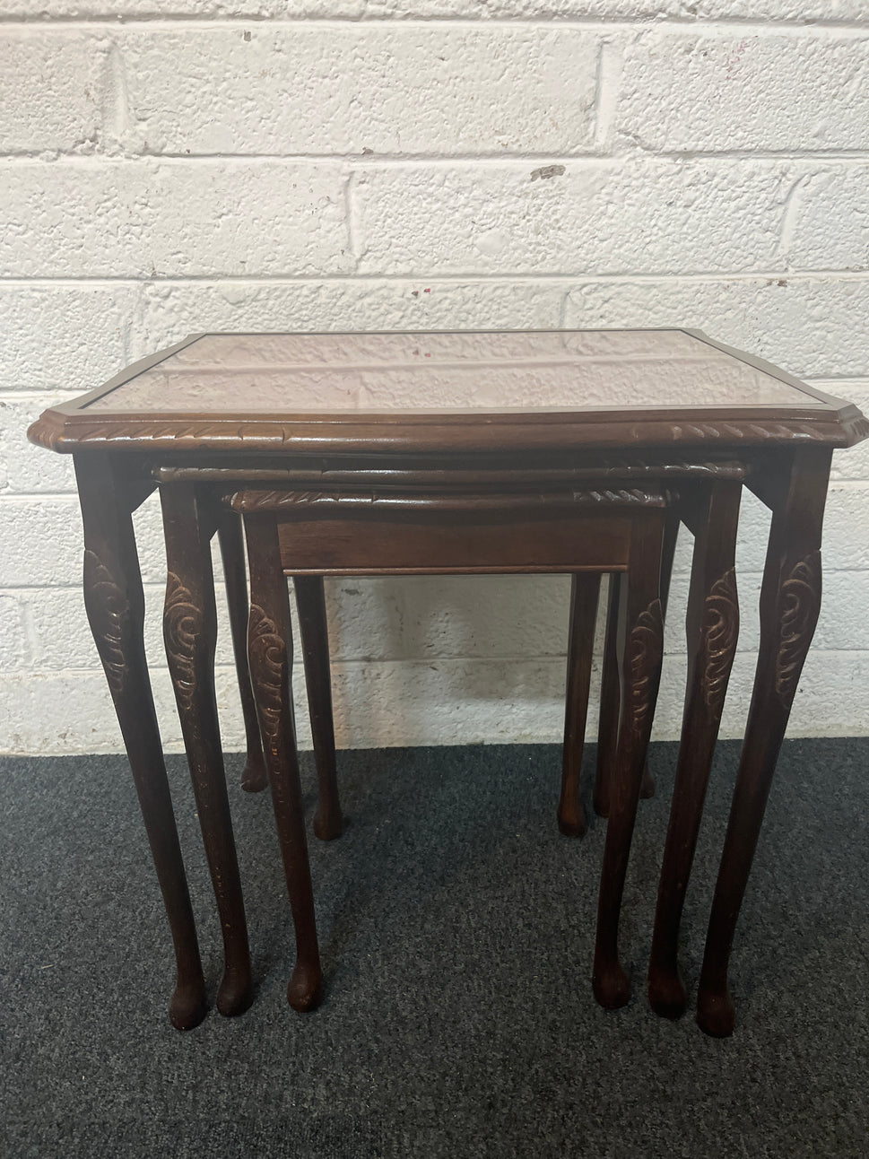 Mahogany nest of tables with glass top and carved detailing 1325