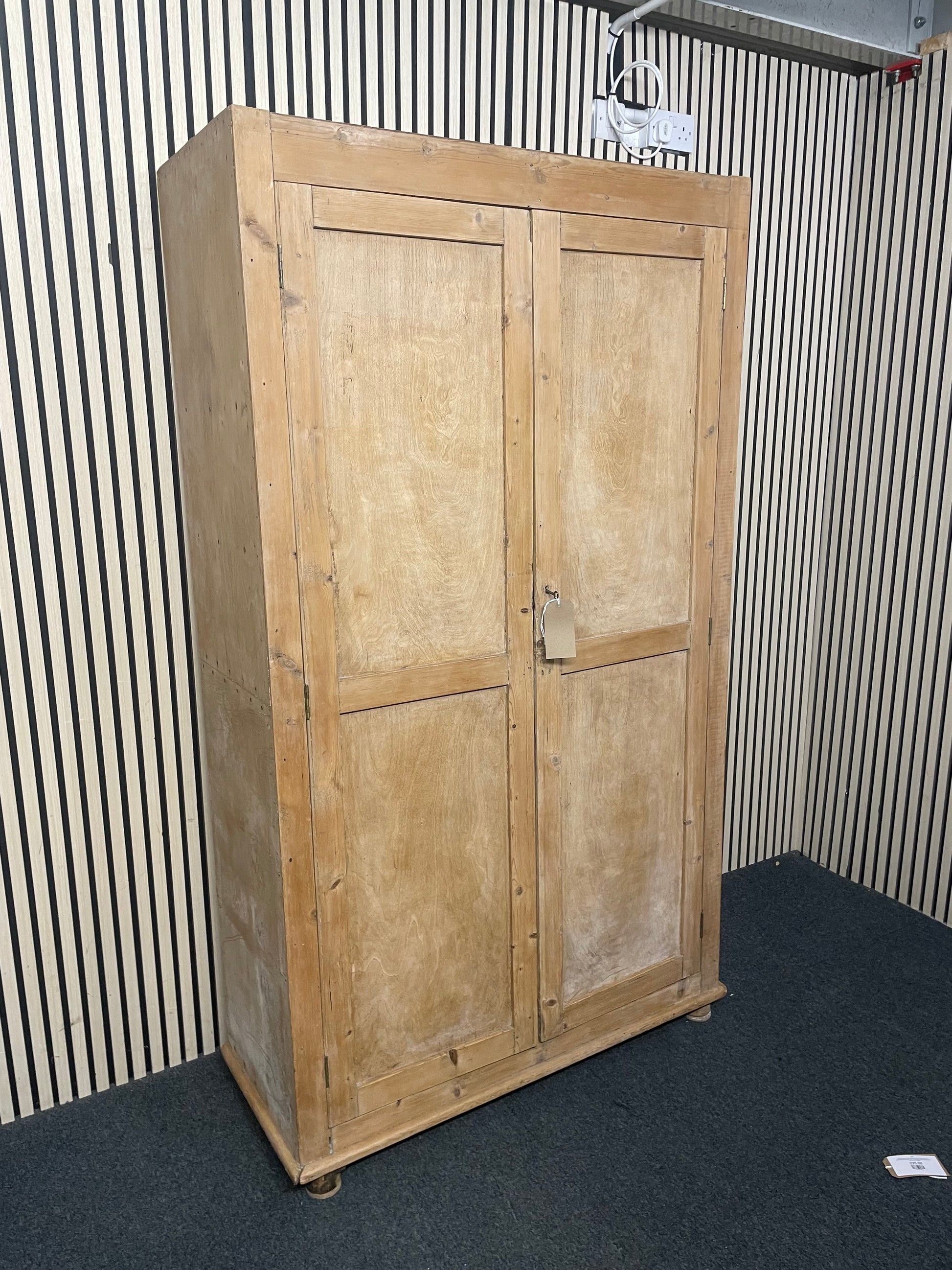Large weathered pine double wardrobe featuring panelled doors and key.(H 197 x W 110 x D 45 cm) 44073