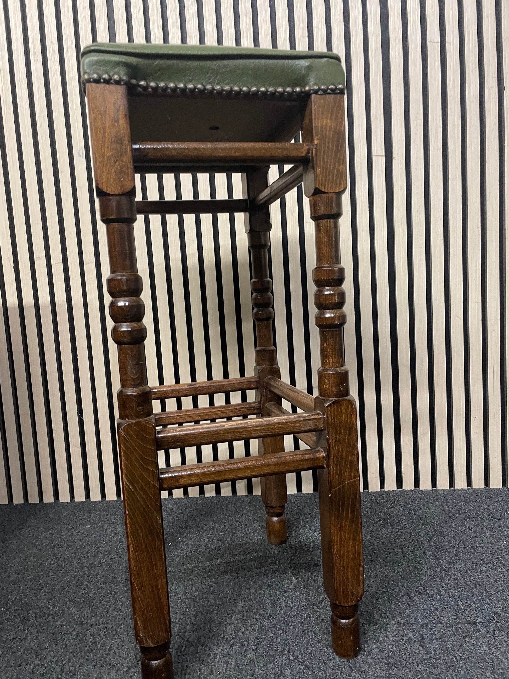 Ornate solid wooden framed high bar stool with green leatherette seat and button design 1126