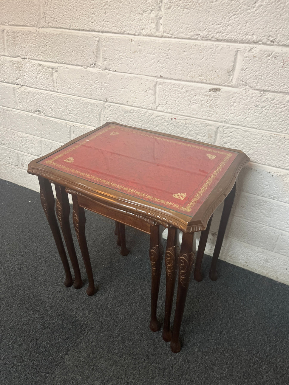 Mahogany nest of tables with glass top and carved detailing 1325