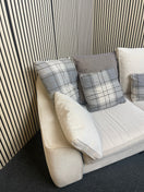 Large curved three-seater fabric sofa with matching scatter cushions. 44592