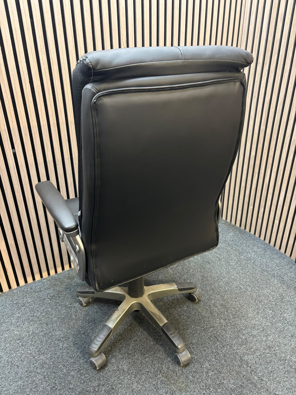 Padded black faux leather executive swivel chair, high back with arms J3950