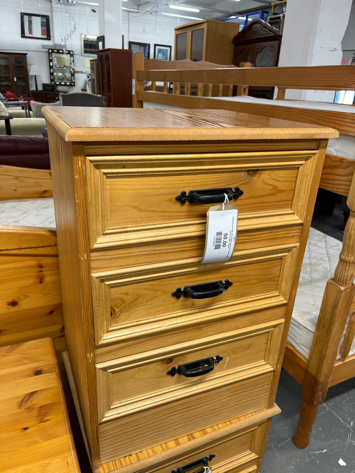 Solid pine bedside chest featuring three drawers with black handles. 44361