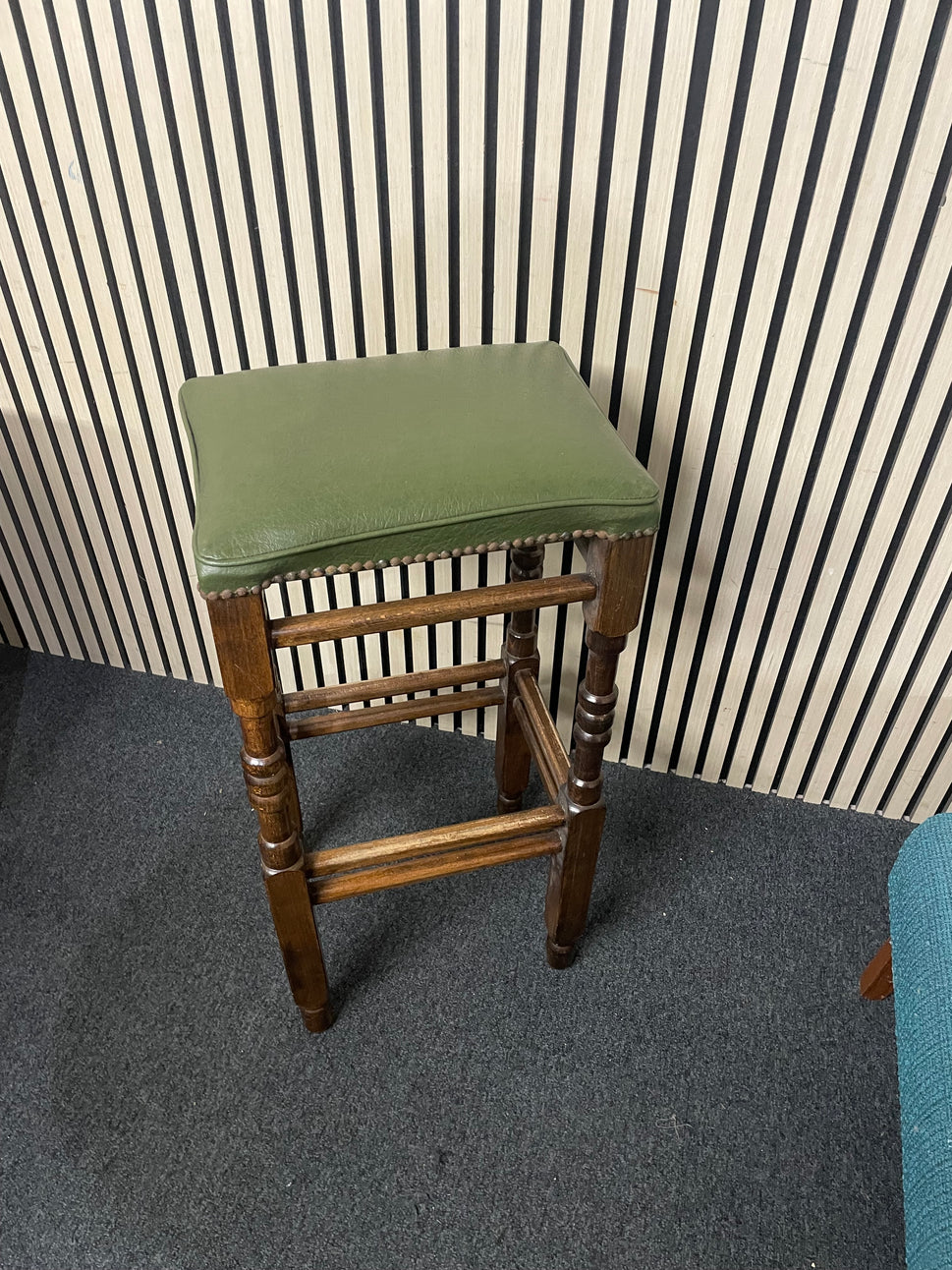 Ornate solid wooden framed high bar stool with green leatherette seat and button design 1126