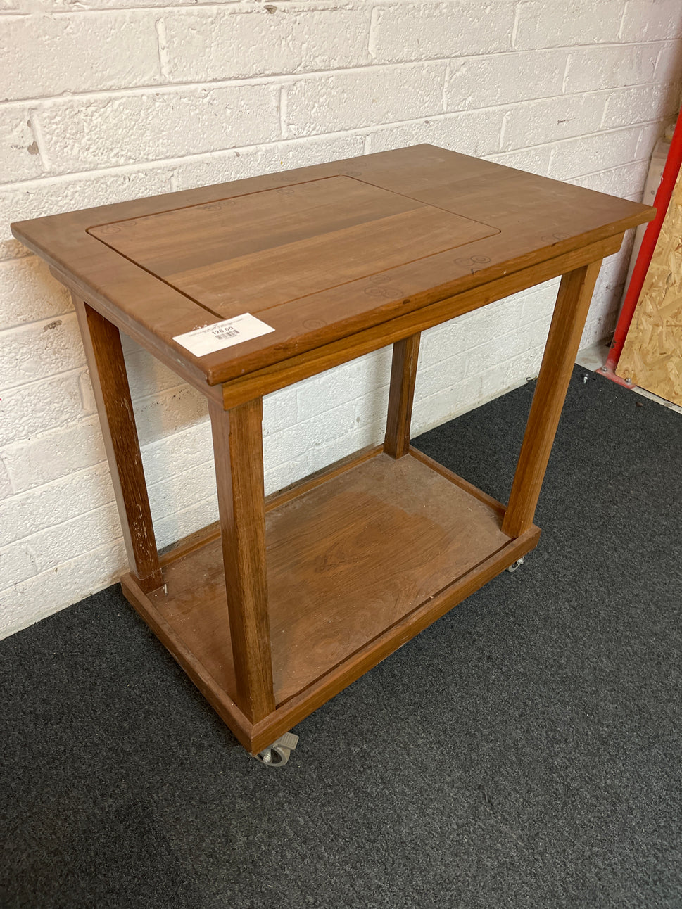 Stained pine high table with circular designs on castors (H 92 x W 90 x D 55 cm) 1325
