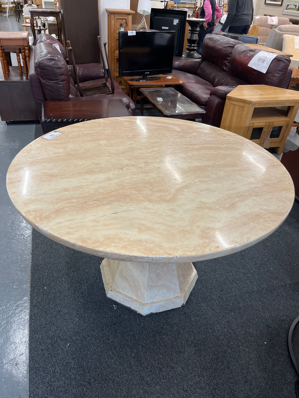 Cream marble effect circular 1300Wx760H central podium base dining table, note damage to parts of edge 2225