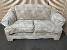 Two seater sofa with blue polka dot pattern and cushions. 44519
