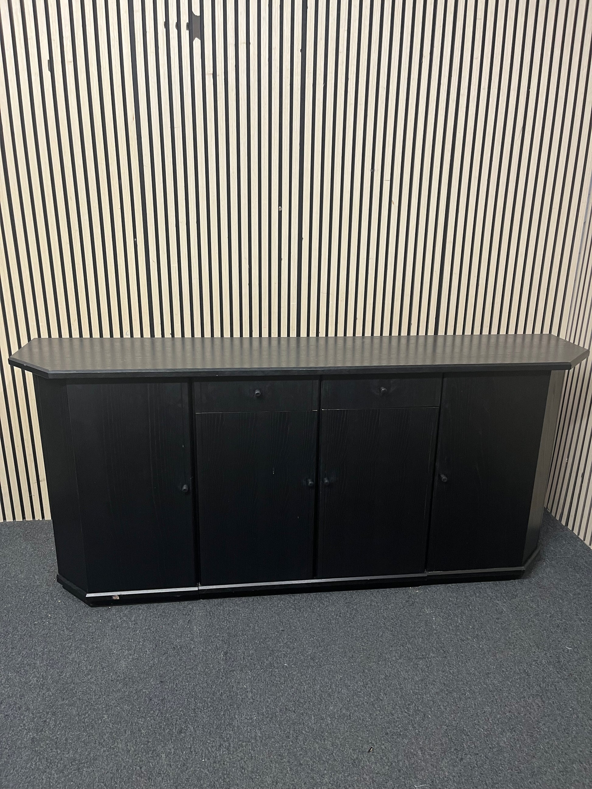 Black low sideboard with three storage doors, good condition. 44030