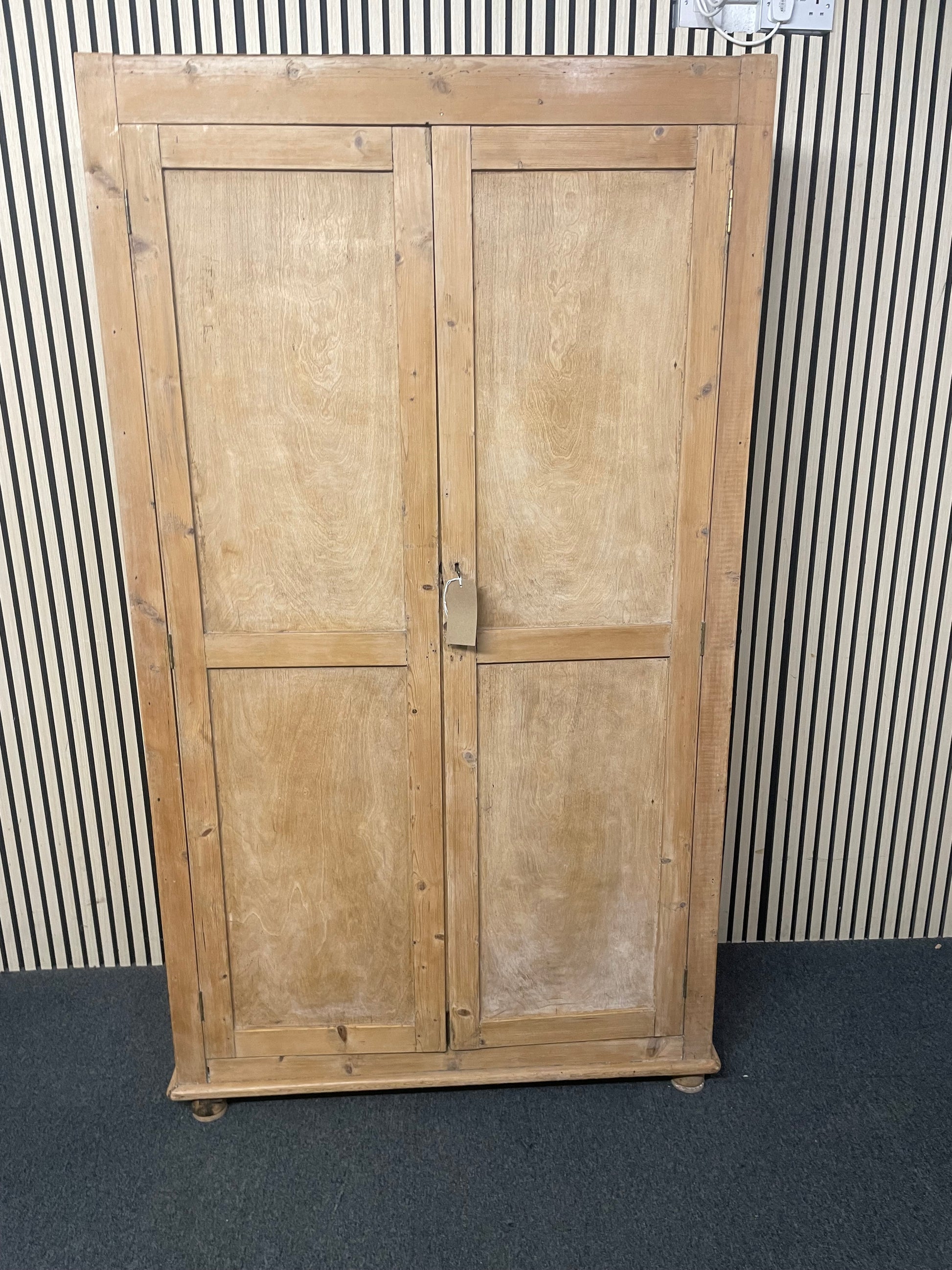 Large weathered pine double wardrobe featuring panelled doors and key.(H 197 x W 110 x D 45 cm) 44073