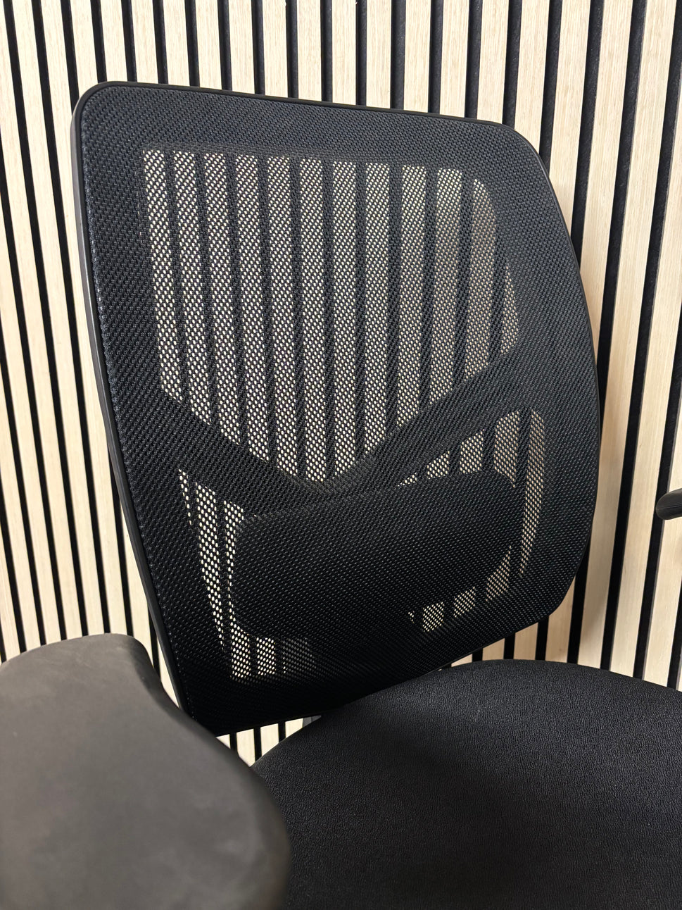 Black mesh back black fabric swivel chair with adjustable arms