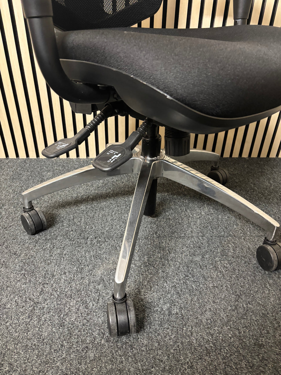 Black mesh back black fabric swivel chair with adjustable arms