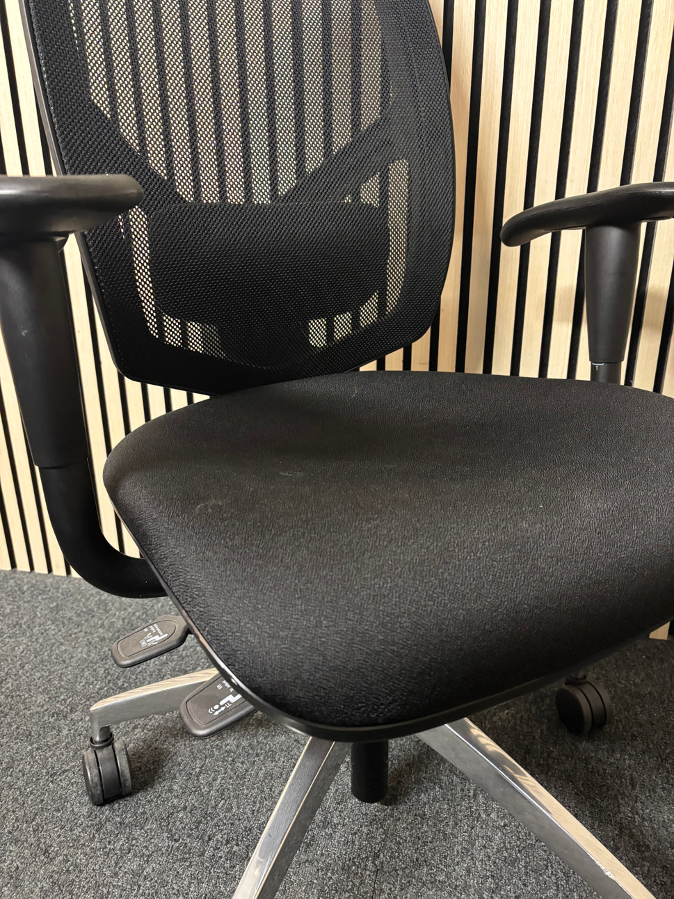 Black mesh back black fabric swivel chair with adjustable arms