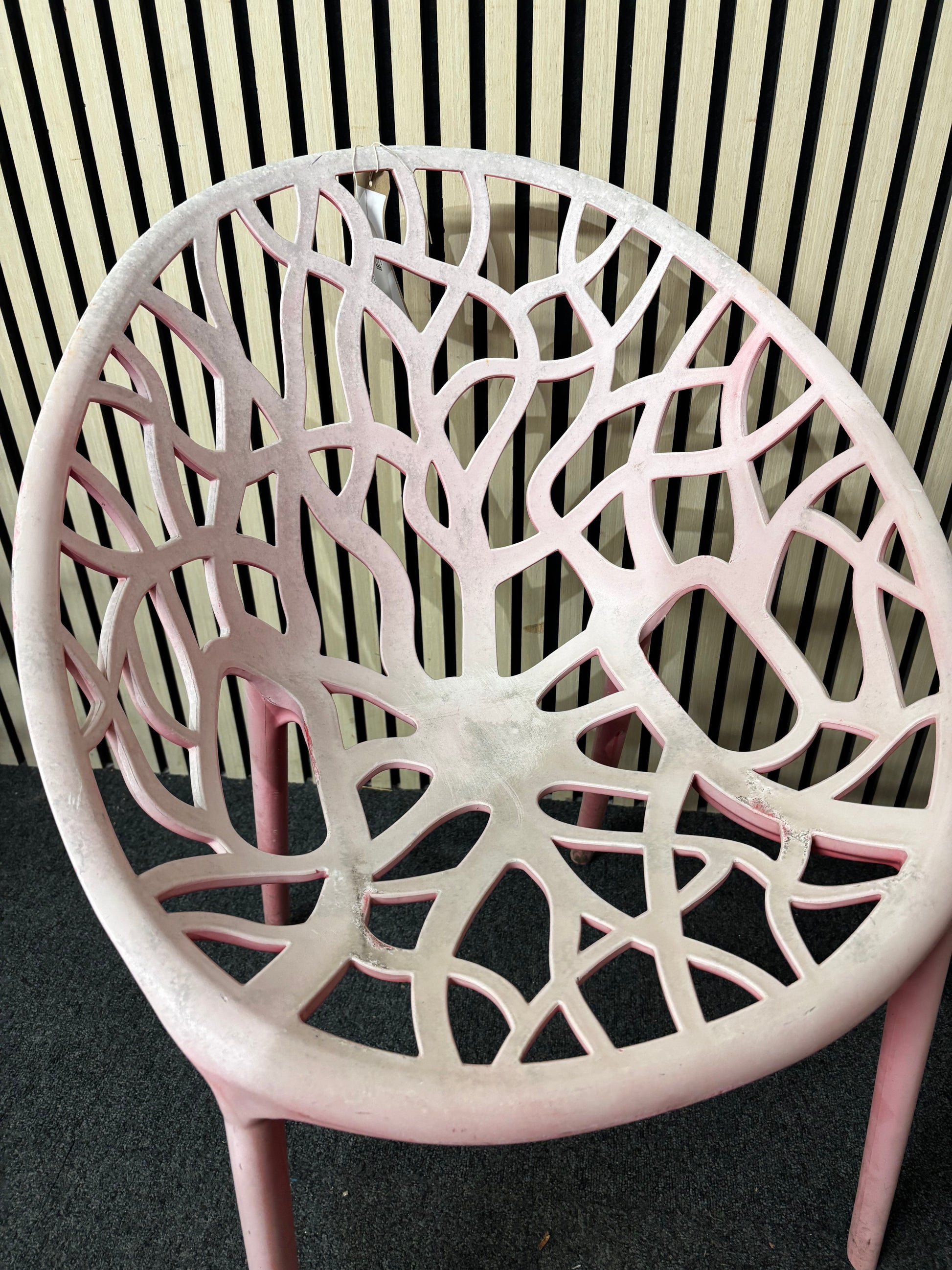 Light red stackable plastic outdoor chair - sun faded 3126