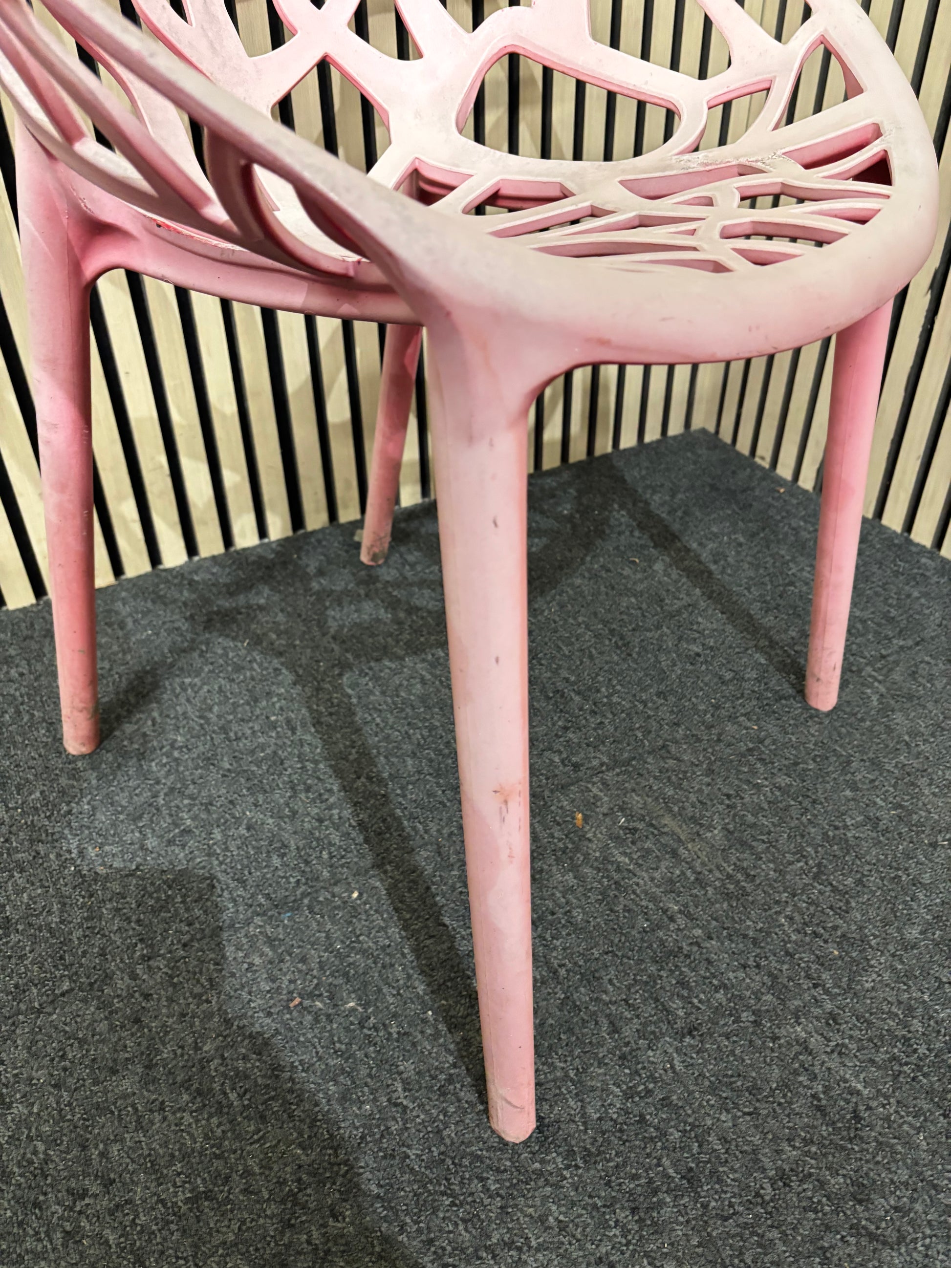 Light red stackable plastic outdoor chair - sun faded 3126