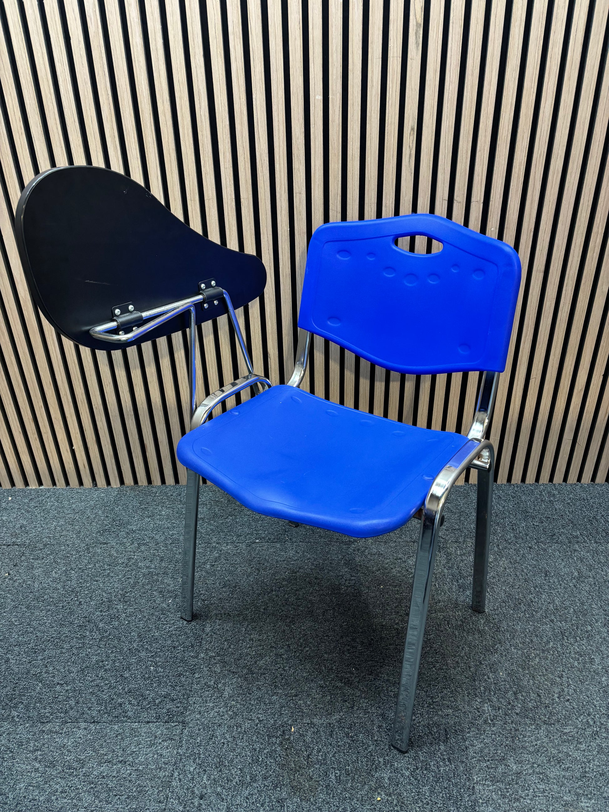 Blue plastic chrome framed stacking chair with removable writing tablet