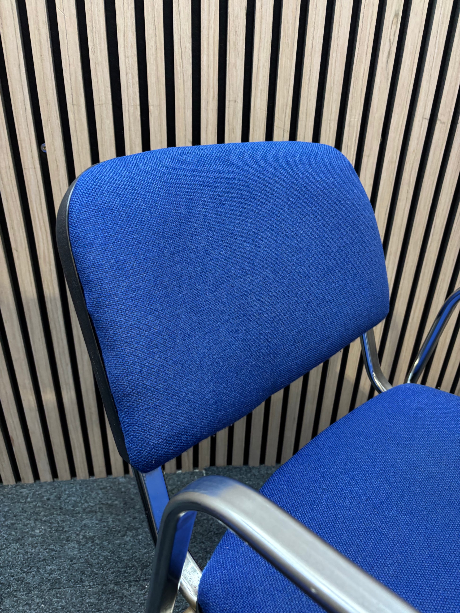 Light blue fabric chrome frame stacking chair with arms