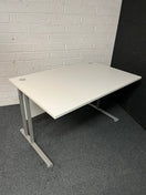 SECONDHAND 1200Lx800Dx720H White cantilever desk with silver metal frame and white modestly panel. IN EXCELLENT CONDITION. Price inclusive of VAT