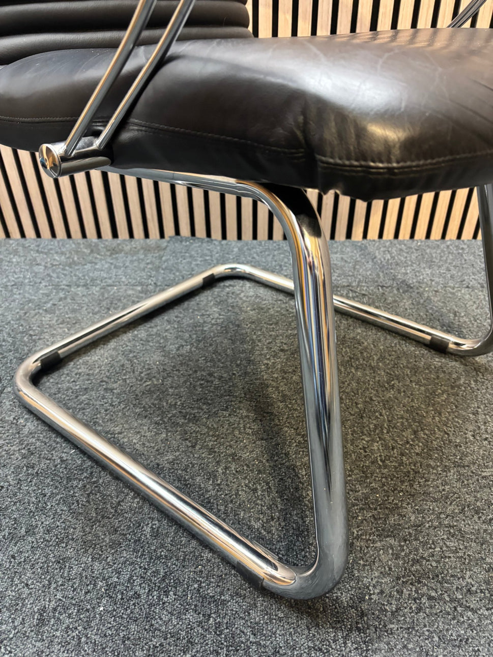 Black leatherette solid metal framed meeting chair with arms