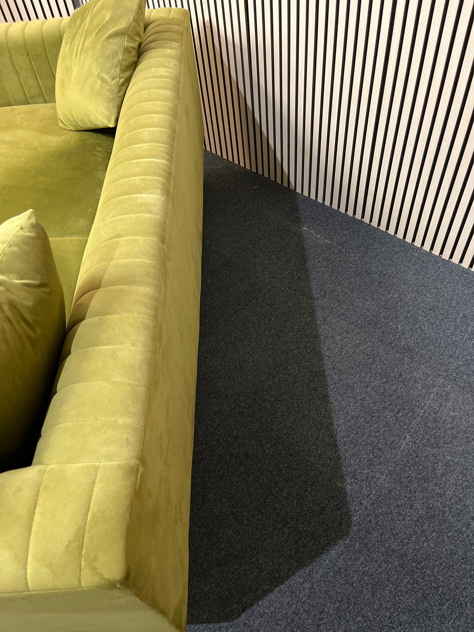 Modern olive green velvet sofa with vertical channel tufting, 2 seat cushions and slim black legs assencted with gold tips( W x 197 L x 81 H x 73 cm)