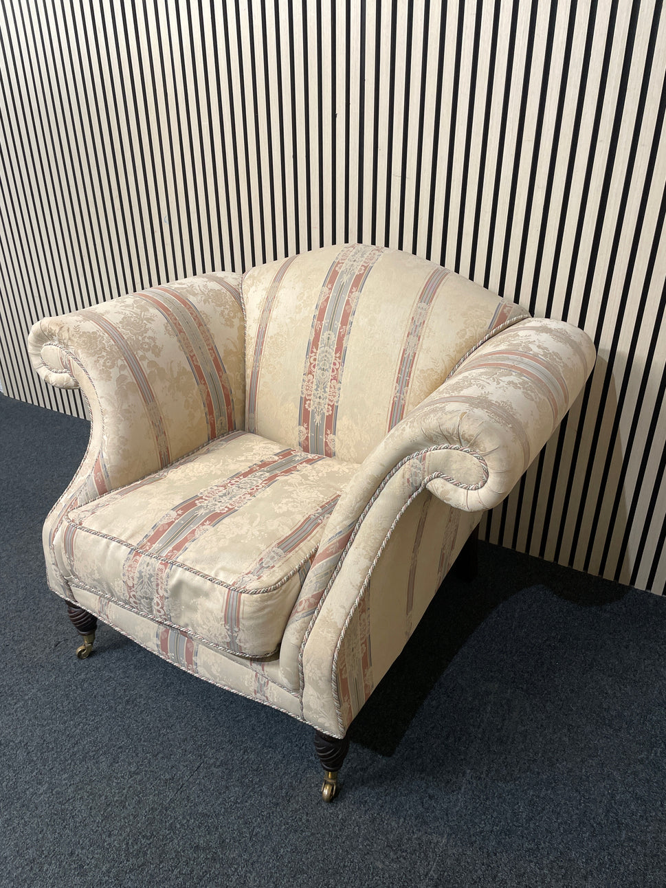 Ornate roll back stripped fabric armchair with castors 2425