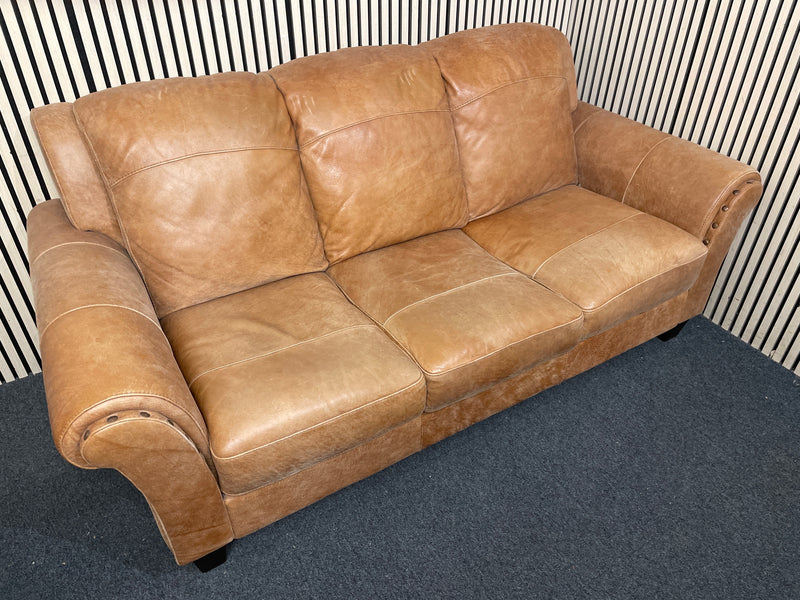 A three-seater tan leather sofa with broad, cushioned armrests W180x94D  44493