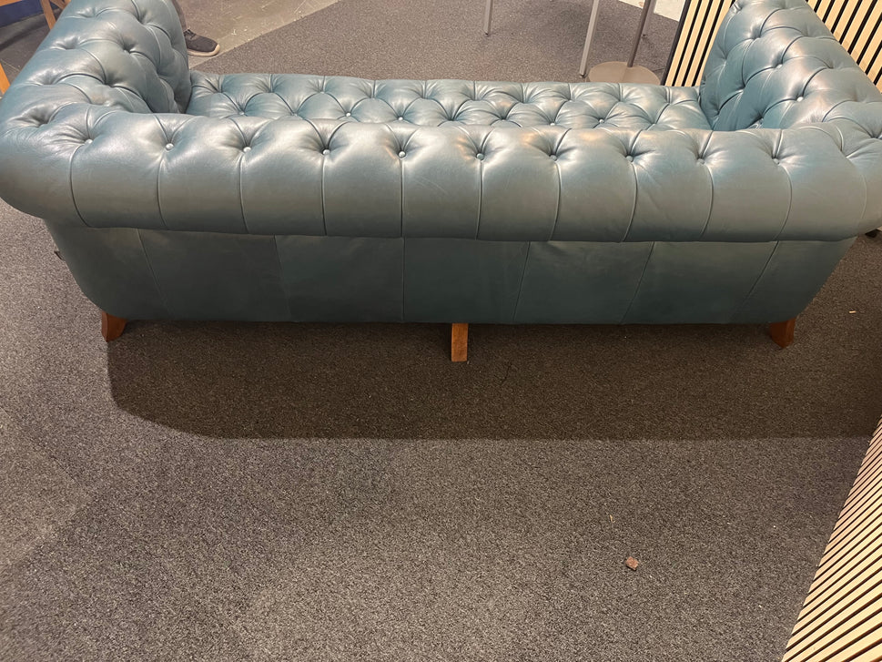 3 seater Chesterfield-style leather sofa in deep teal leather with tufted upholstery, rolled arms, and wooden legs accented by brass nailhead trim (width 230 cm) 1425