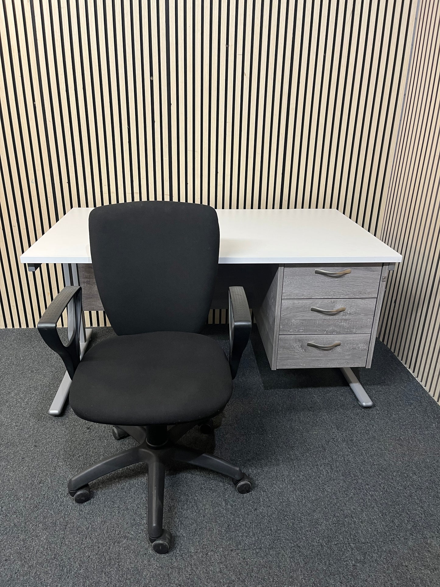 White cantilever framed 1400 x 800 desk with grey oak fixed pedestal and modesty panel