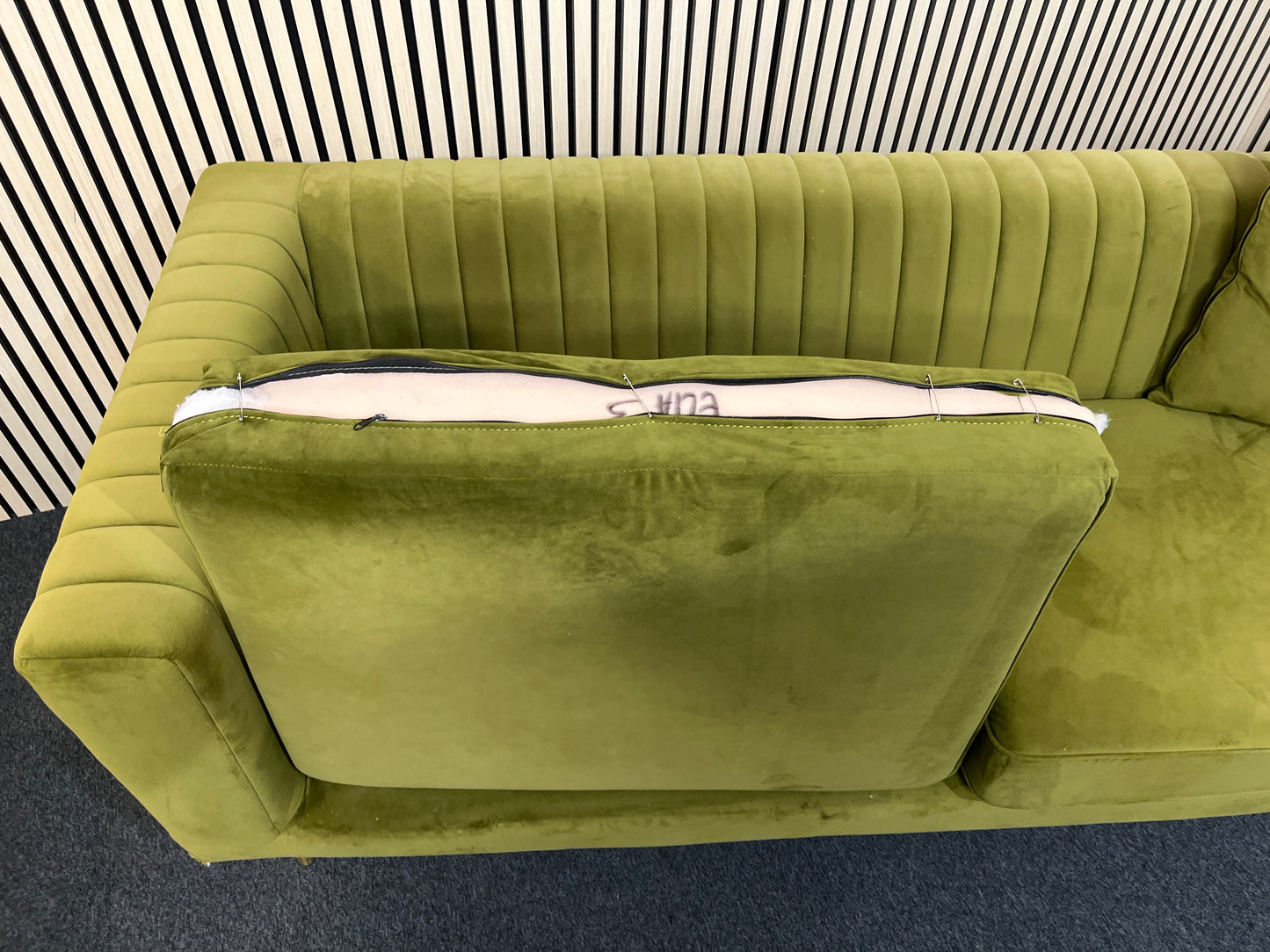 Modern olive green velvet sofa with vertical channel tufting, 2 seat cushions and slim black legs assencted with gold tips( W x 197 L x 81 H x 73 cm)