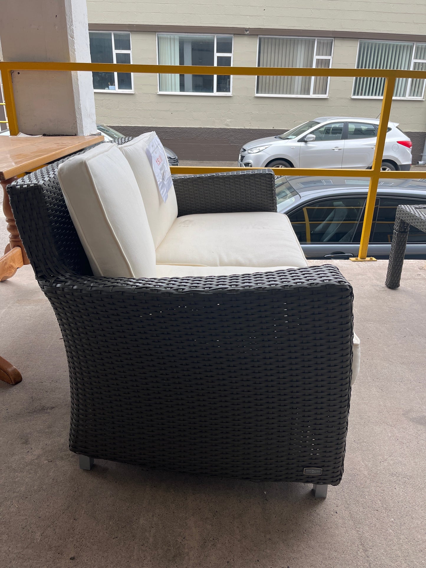 Rattan 2 seater conservatory sofa with cream cushions 2225