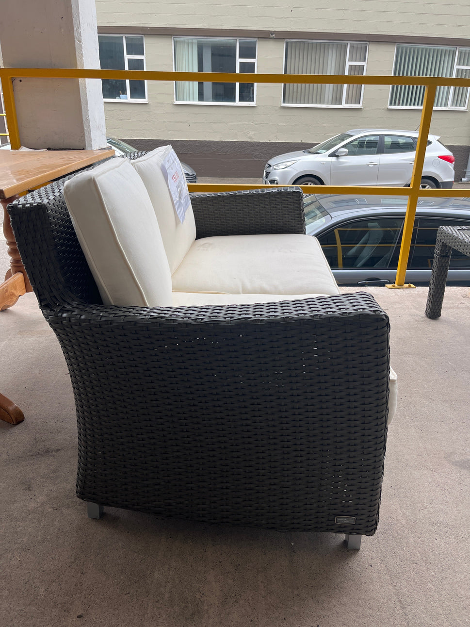 Rattan 2 seater conservatory sofa with cream cushions 2225