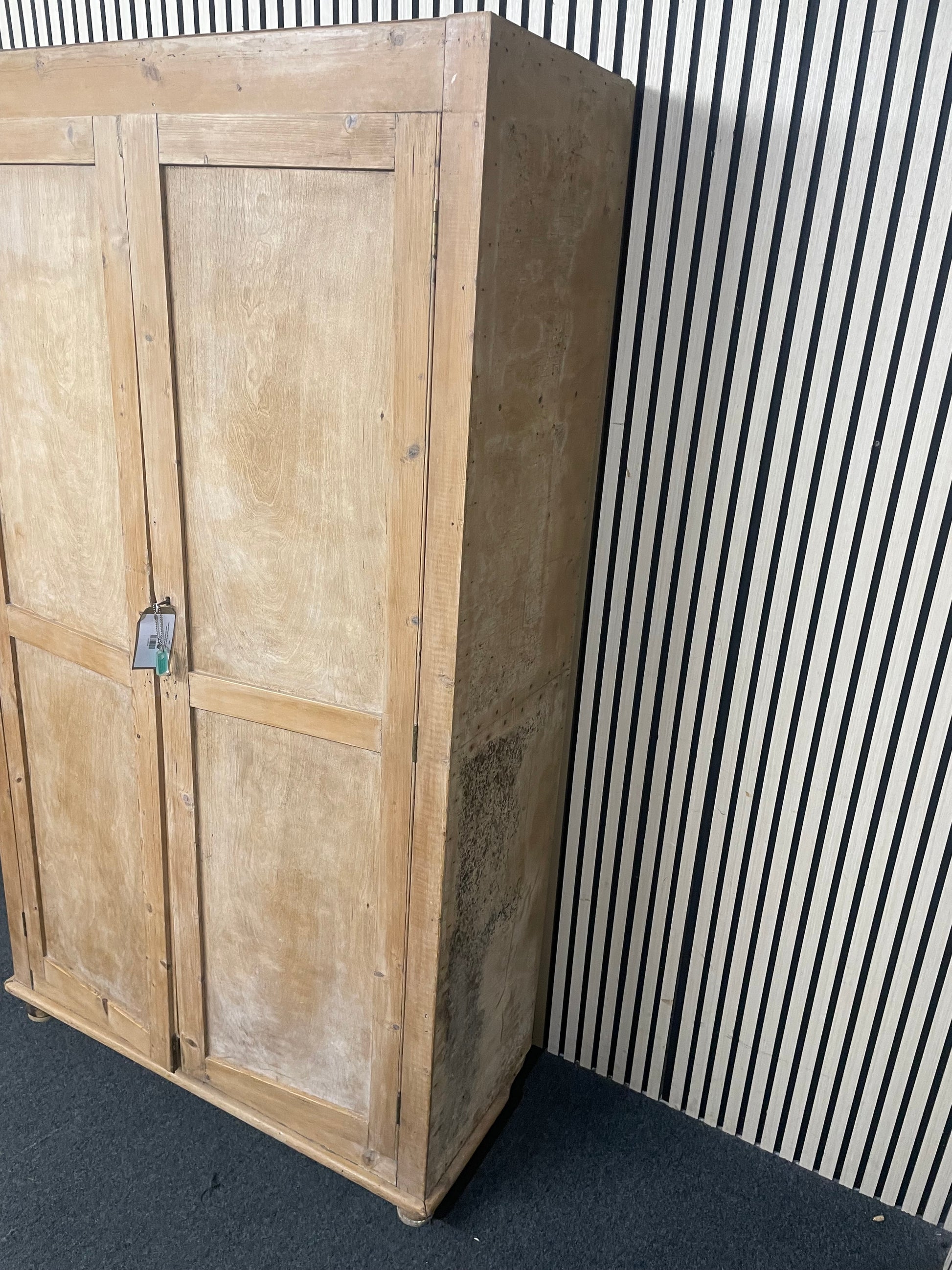 Large weathered pine double wardrobe featuring panelled doors and key.(H 197 x W 110 x D 45 cm)  44073