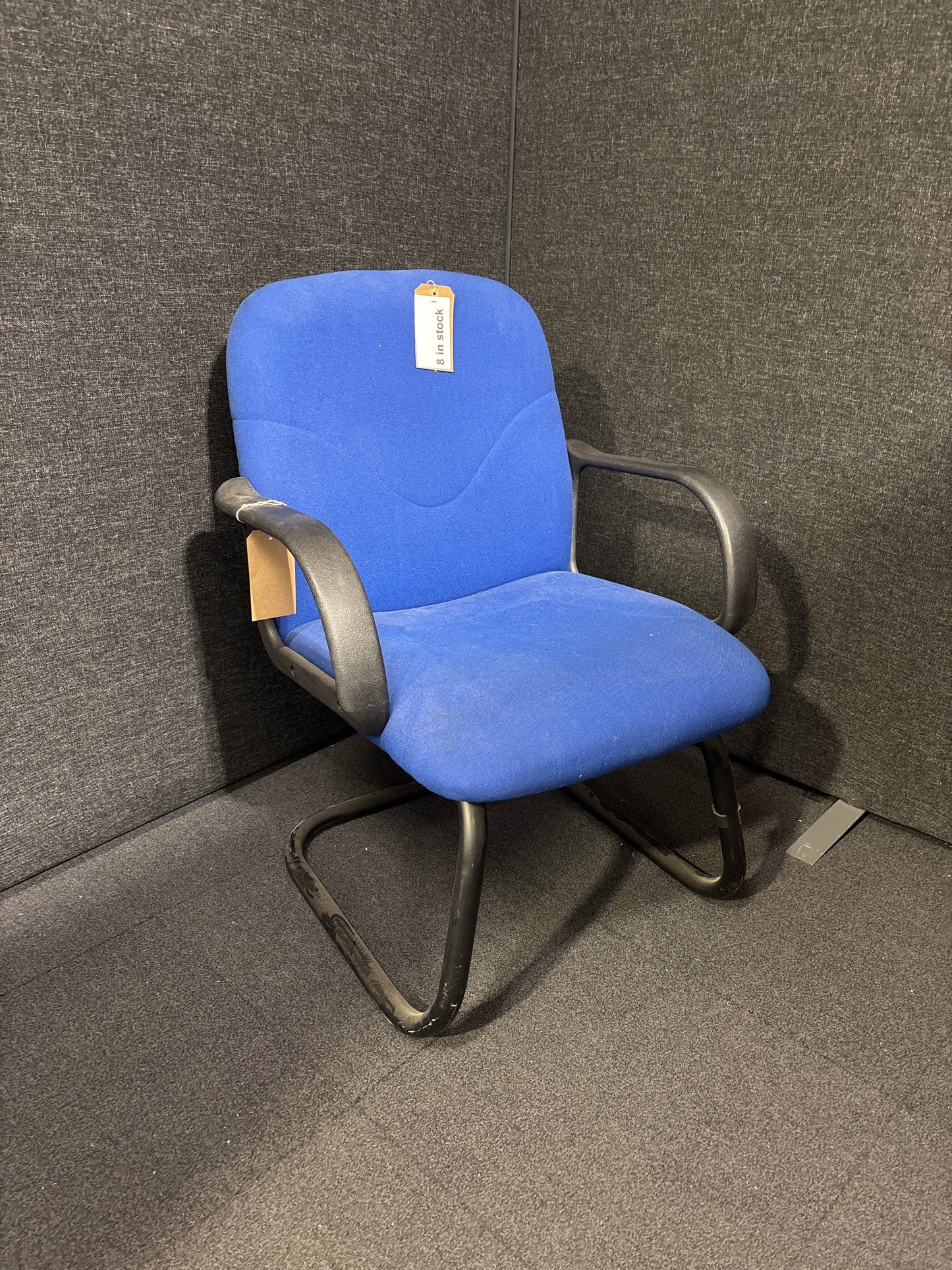 Blue fabric low back cantilever black framed meeting chair with arms