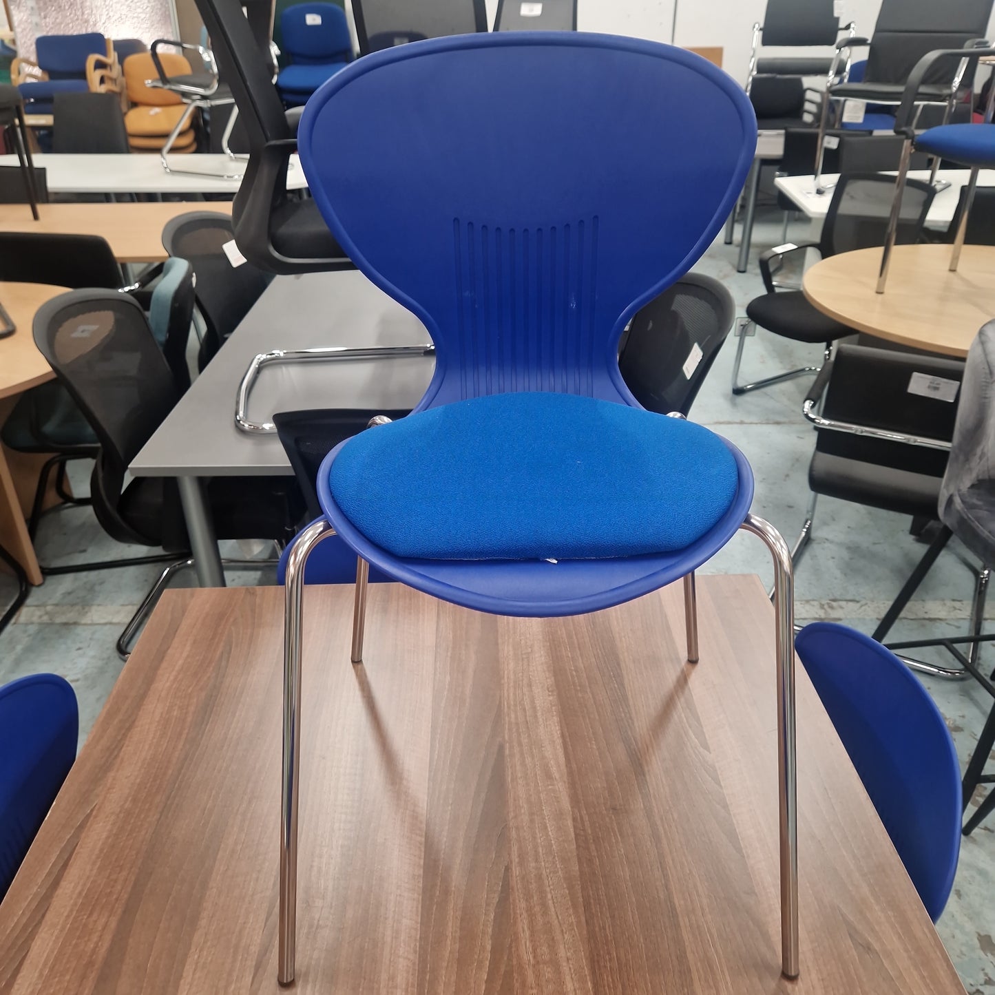 Plastic blue stacking chair blue fabric seat, chrome frame