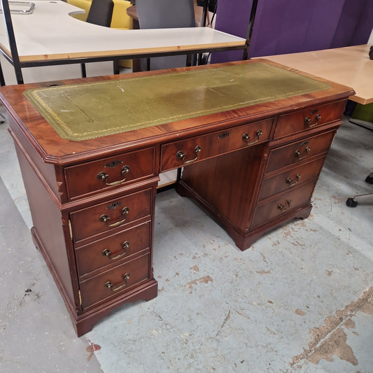Ornate reproduction mahogany partners desk with drawers and green and gold emobossed leather top